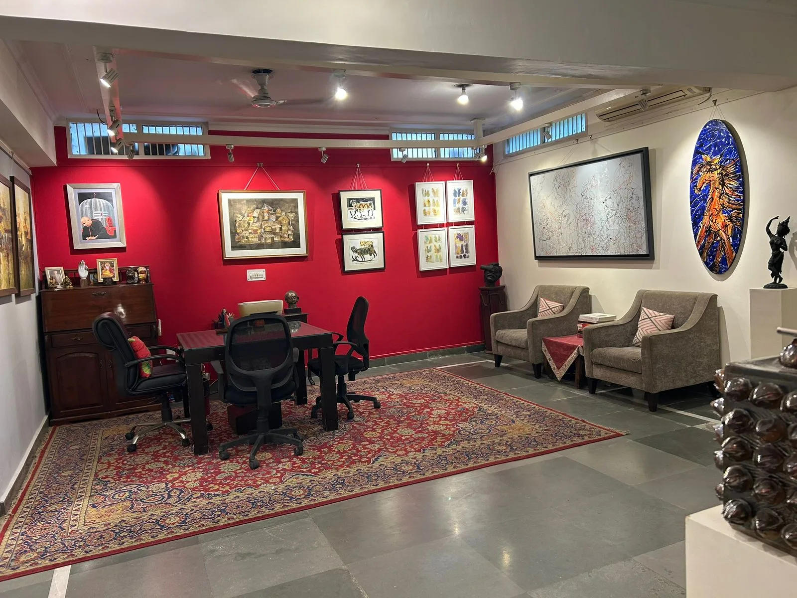 Gallery One — viewing room with seating and curated wall display